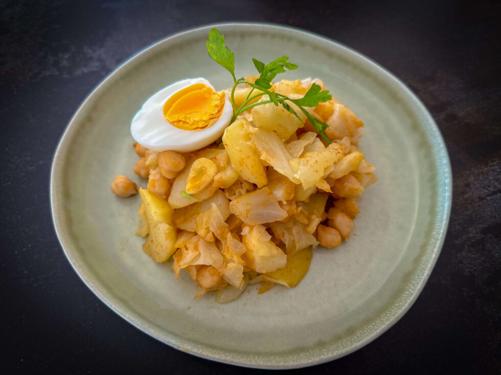Traditional Cabbage with chickpeas and potatoes stew In Spain